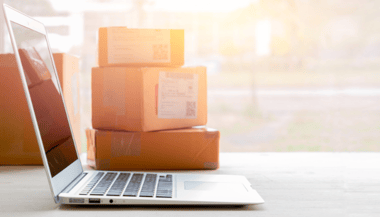 Ordinateur et paquets pour illustrer le e-commerce